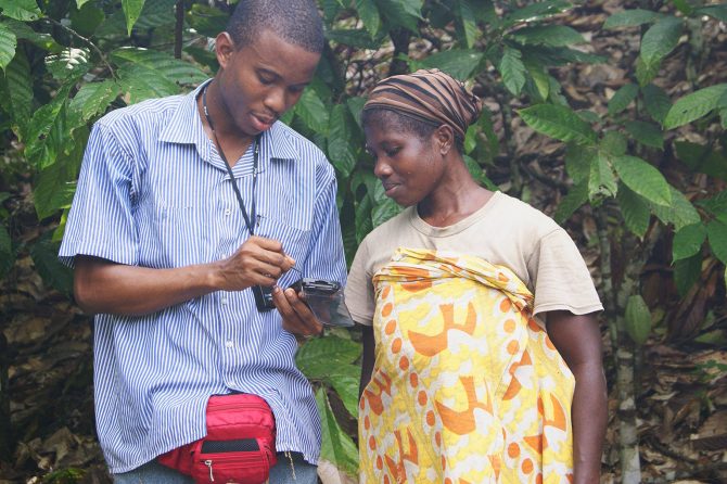 Staff training a farmer on use of equipment