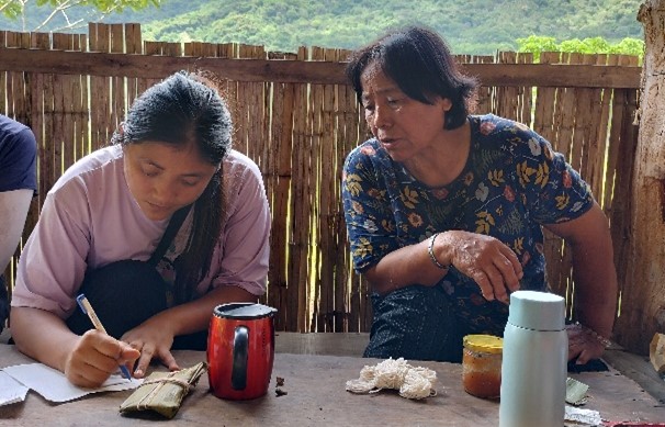 A young farmer interviewing an elder